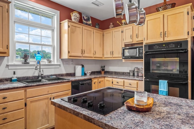 kitchen featuring sink, black appliances, and light brown cabinets