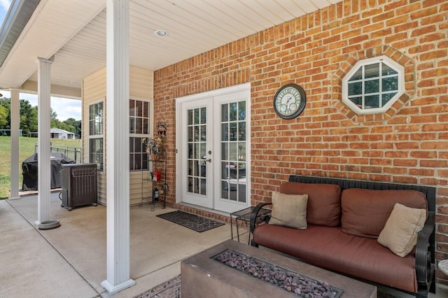 view of patio / terrace featuring french doors, grilling area, and an outdoor fire pit