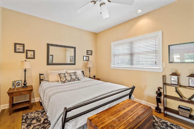 bedroom featuring light hardwood / wood-style flooring and ceiling fan