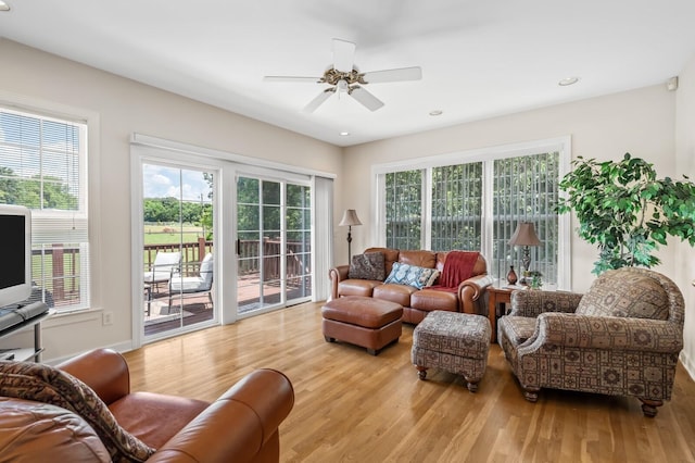 living room featuring light hardwood / wood-style flooring and ceiling fan