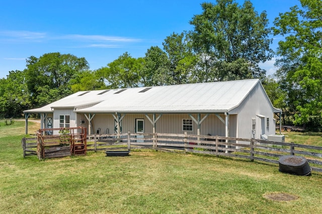 back of property featuring an outbuilding and cooling unit