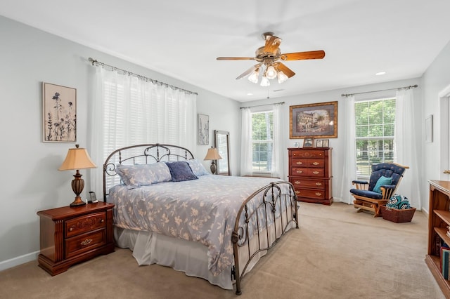 bedroom featuring ceiling fan and light carpet