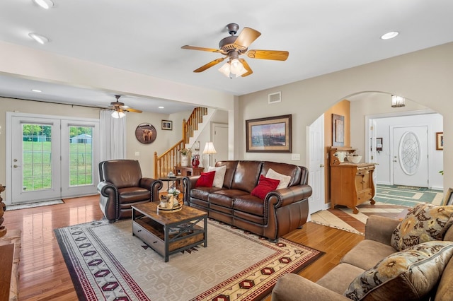 living room featuring light hardwood / wood-style floors and ceiling fan