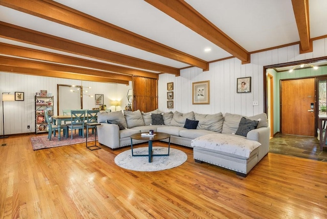 living room with light hardwood / wood-style flooring and beamed ceiling