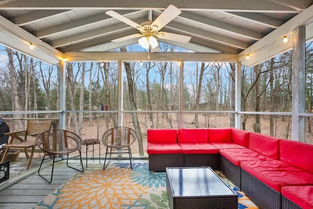 sunroom / solarium with vaulted ceiling with beams, ceiling fan, and a healthy amount of sunlight