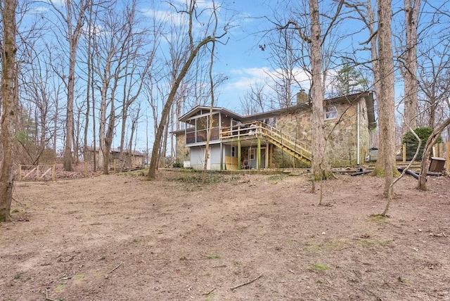 rear view of property with a wooden deck