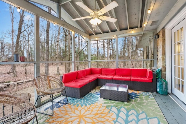 sunroom / solarium with ceiling fan and lofted ceiling