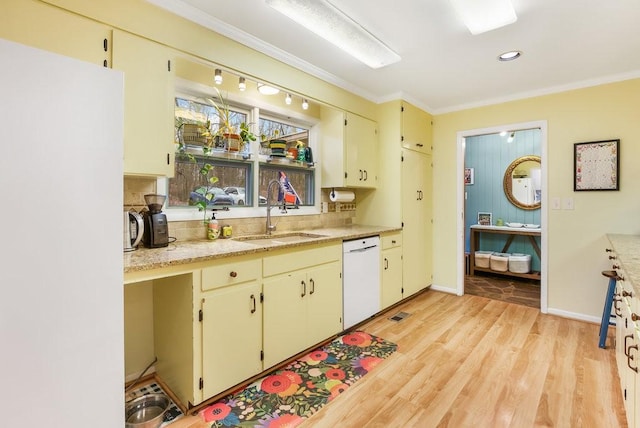 kitchen featuring light wood-type flooring, white appliances, sink, and ornamental molding