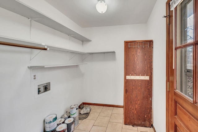 laundry area featuring hookup for a washing machine, light tile patterned floors, and a wealth of natural light