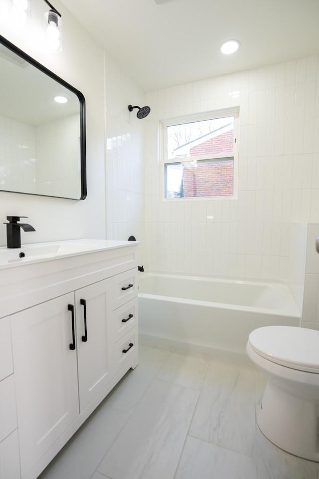 full bathroom with vanity, toilet, and tiled shower / bath