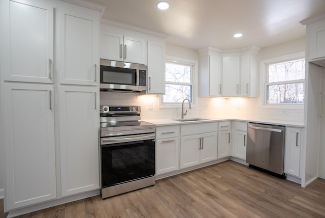 kitchen featuring sink, white cabinets, and appliances with stainless steel finishes