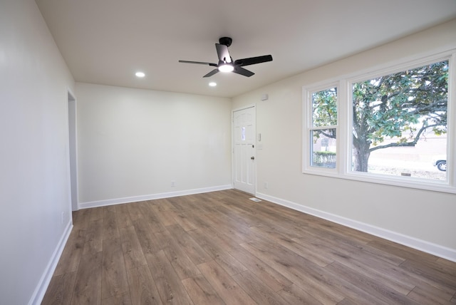 unfurnished room with ceiling fan and hardwood / wood-style flooring