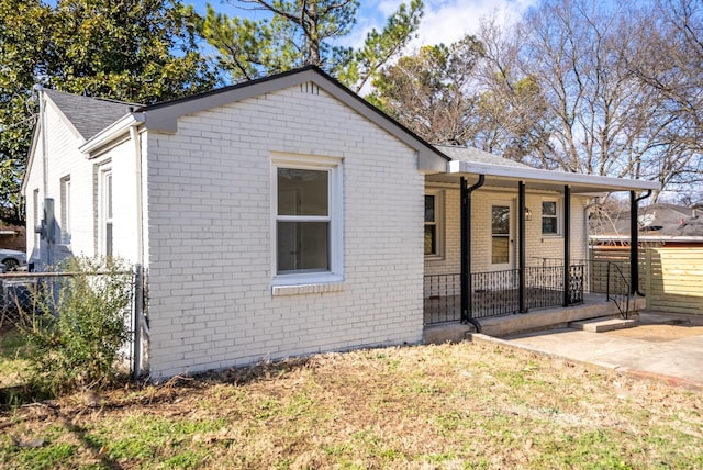 bungalow-style house featuring a front yard and a patio area