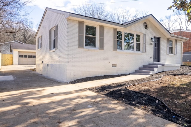 view of front facade with an outbuilding and a garage