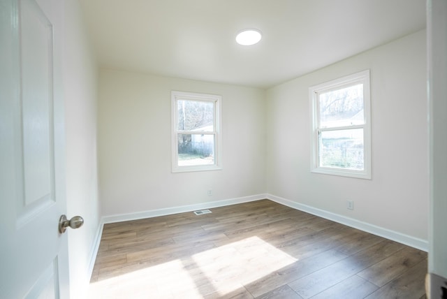 spare room featuring light hardwood / wood-style floors