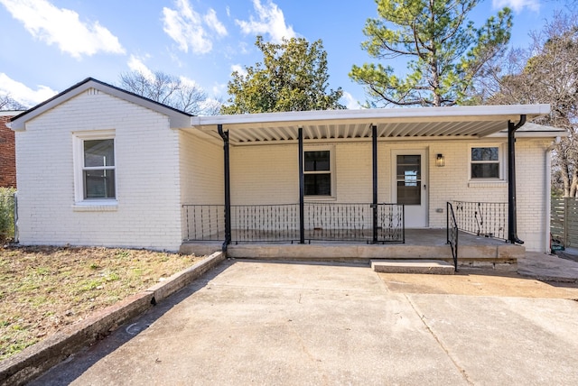 ranch-style house with a porch and a carport