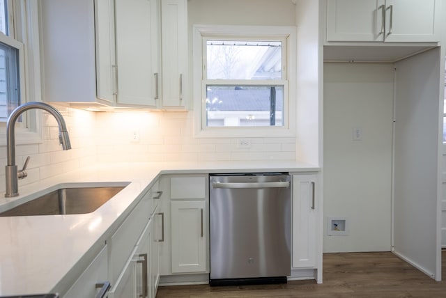 kitchen featuring dark hardwood / wood-style flooring, backsplash, white cabinets, sink, and dishwasher