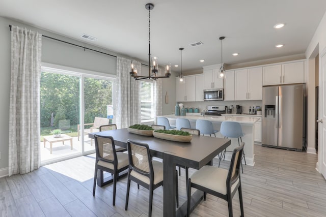 dining room featuring a chandelier and a healthy amount of sunlight