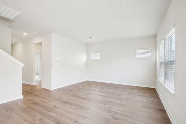 unfurnished room featuring baseboards, recessed lighting, visible vents, and light wood-style floors