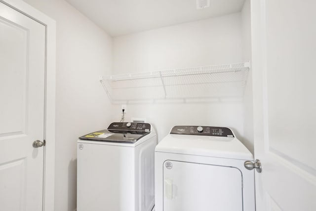 laundry area with laundry area, independent washer and dryer, and visible vents