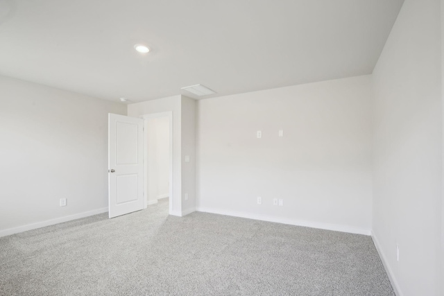 carpeted empty room featuring recessed lighting and baseboards