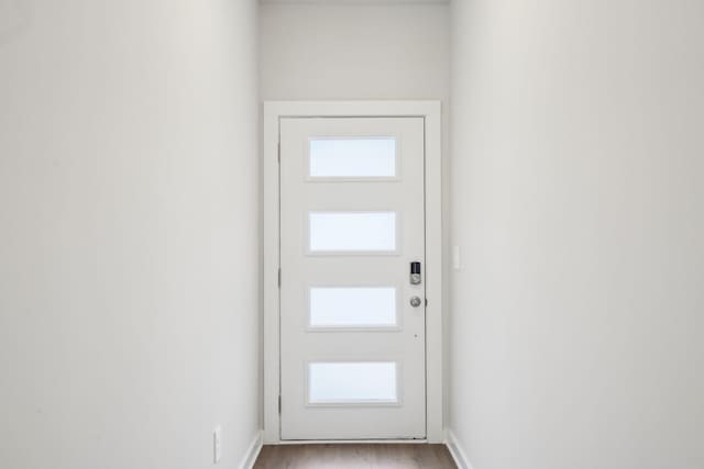 entryway with light wood-type flooring and baseboards