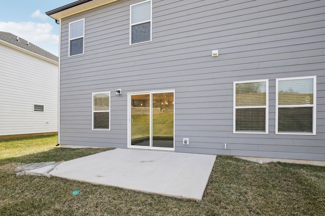 back of house with a patio area and a yard