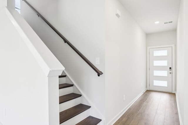 entrance foyer with recessed lighting, visible vents, stairway, light wood-style floors, and baseboards