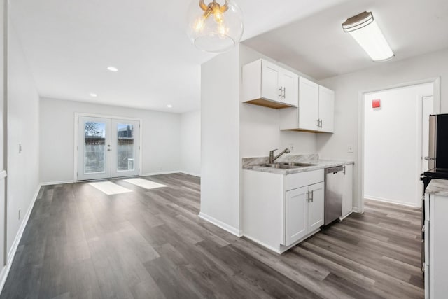 kitchen featuring white cabinetry, dishwasher, french doors, dark wood-type flooring, and sink