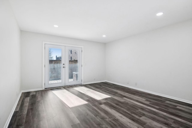 spare room featuring dark wood-type flooring and french doors