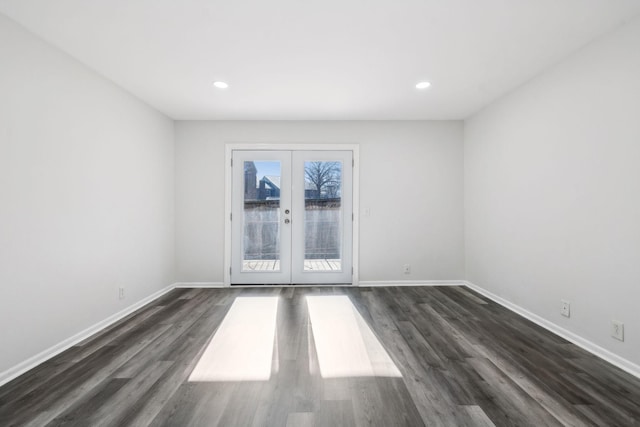 spare room with dark hardwood / wood-style flooring and french doors