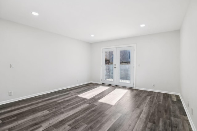 spare room featuring dark hardwood / wood-style flooring and french doors