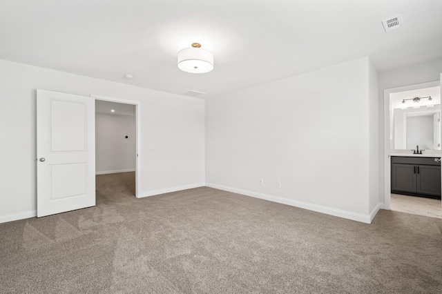 empty room with light carpet and sink