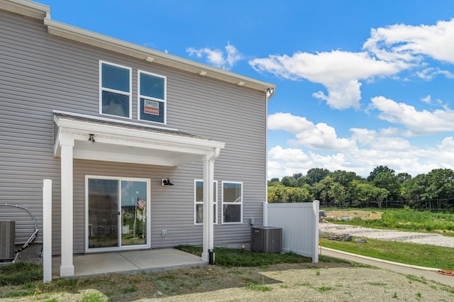 rear view of property with a patio and central AC unit