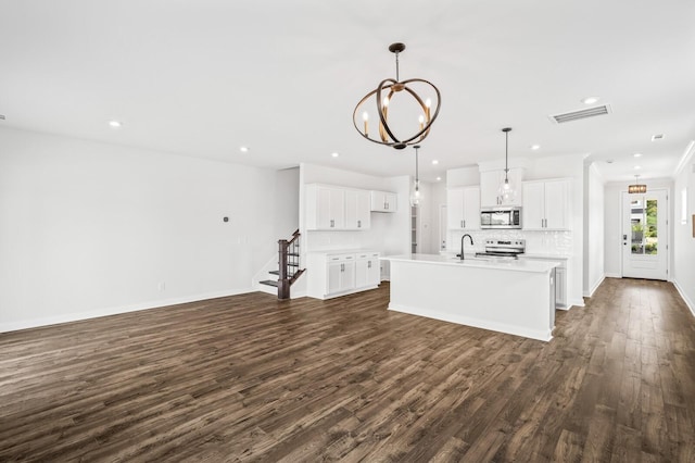 unfurnished living room with sink, dark hardwood / wood-style flooring, and a notable chandelier