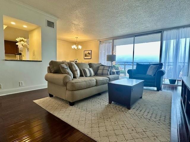 living room featuring floor to ceiling windows, crown molding, dark wood-type flooring, and an inviting chandelier