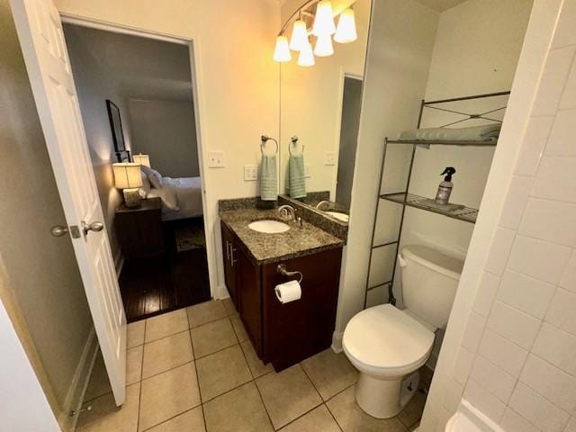 bathroom with tile patterned floors, vanity, and toilet