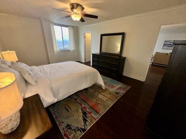 bedroom with ornamental molding, a textured ceiling, ceiling fan, and dark wood-type flooring