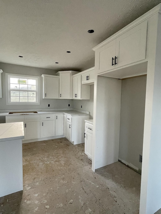 kitchen featuring white cabinets and cooktop