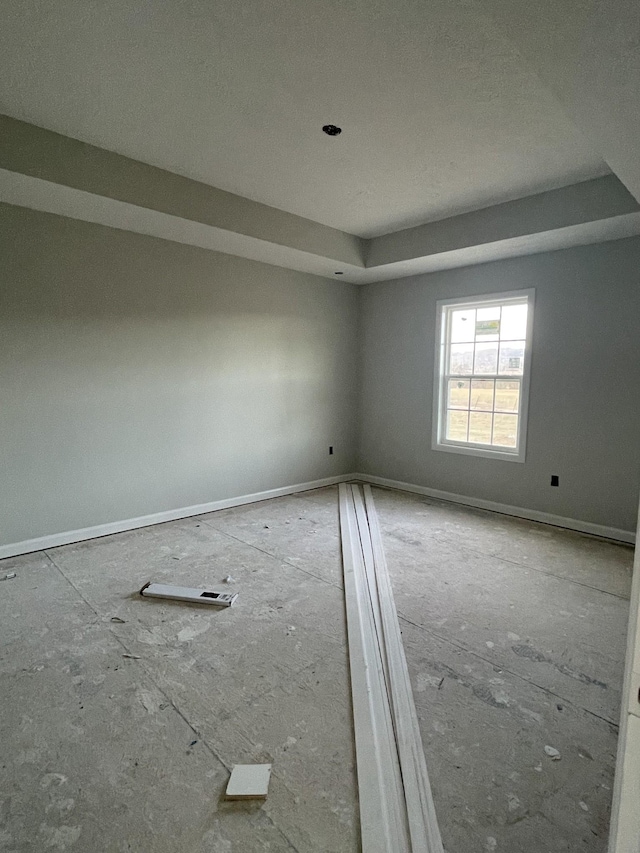 empty room featuring a raised ceiling