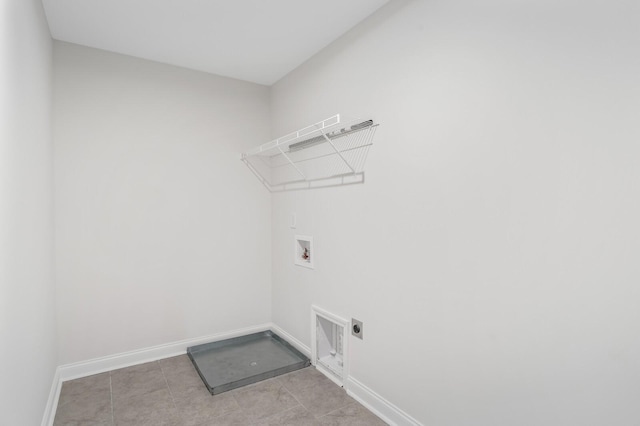 laundry area with hookup for an electric dryer, light tile patterned flooring, and hookup for a washing machine