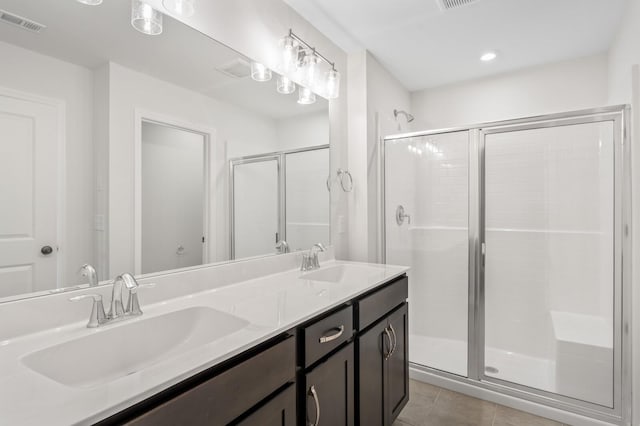 bathroom with tile patterned flooring, vanity, and an enclosed shower