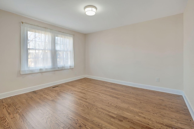 unfurnished room featuring wood-type flooring