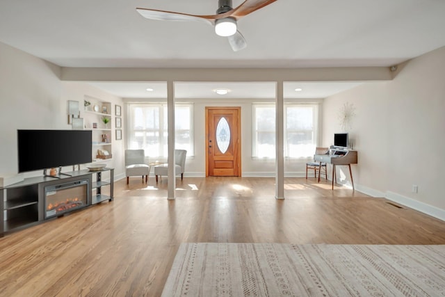 entryway featuring ceiling fan, light wood-type flooring, and a wealth of natural light