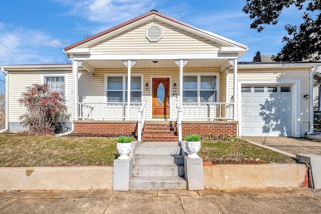 view of front of house with a garage, covered porch, and a front yard