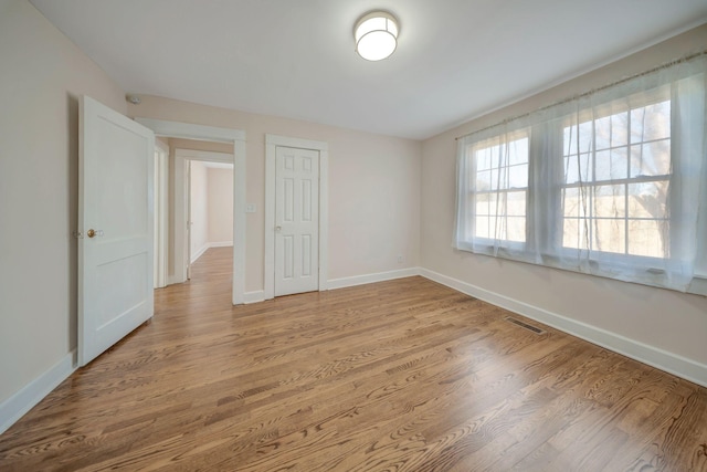 unfurnished room featuring light hardwood / wood-style floors