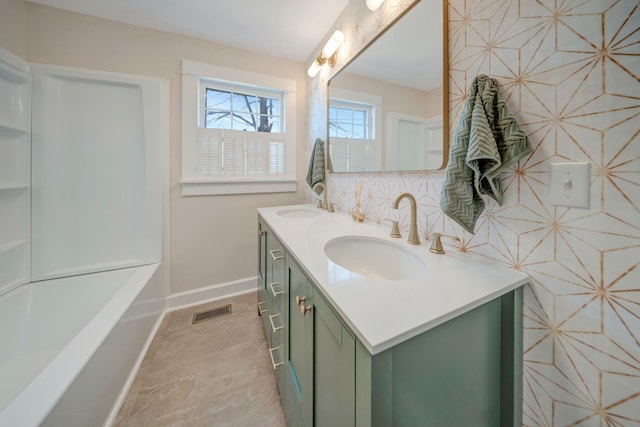 bathroom with a bathtub, tile patterned flooring, and vanity