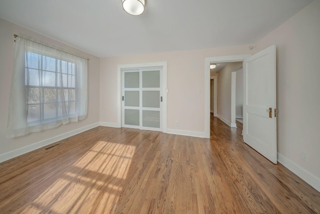 empty room with hardwood / wood-style flooring