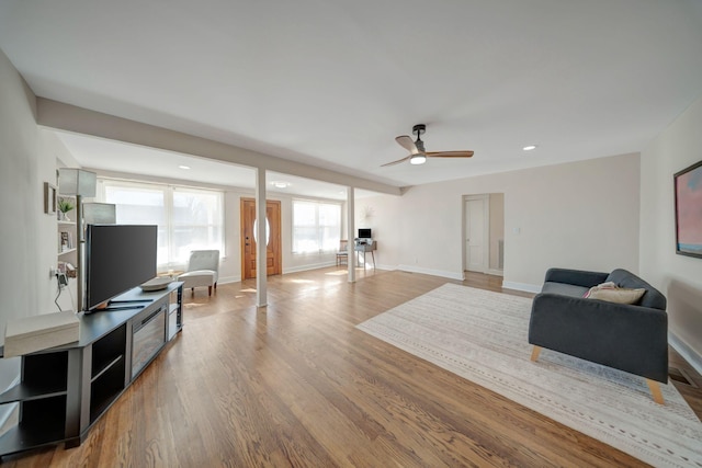 living room with light hardwood / wood-style floors and ceiling fan