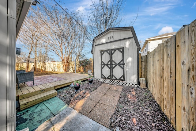 view of patio / terrace with a deck and a storage shed